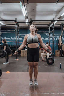 An athlete mid-workout using a jump rope in a bright, airy space