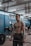 A fit person exercising in a bright gym, showcasing strength and determination.