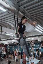 a woman doing aerial exercises in a gym