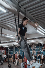 a woman doing aerial exercises in a gym