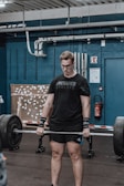 An athlete lifting weights with determination.