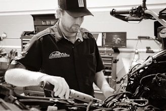 a man working on a motorcycle in a garage