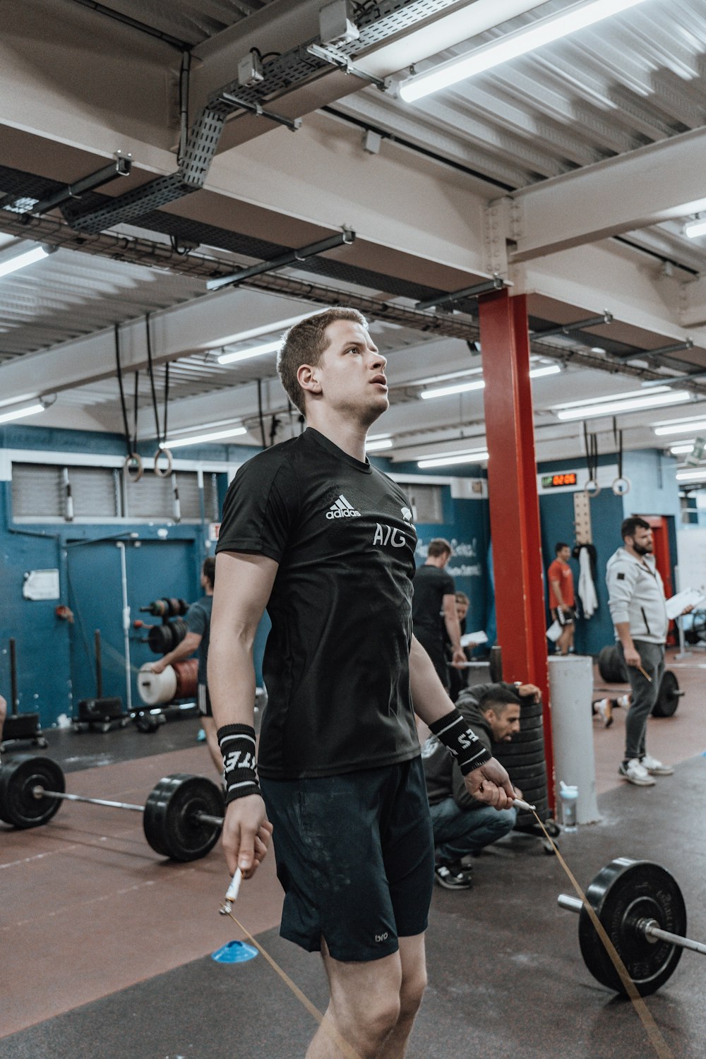 a man holding a barbell in a gym