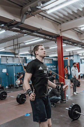 An instructor demonstrating advanced jump rope techniques in a bright studio.