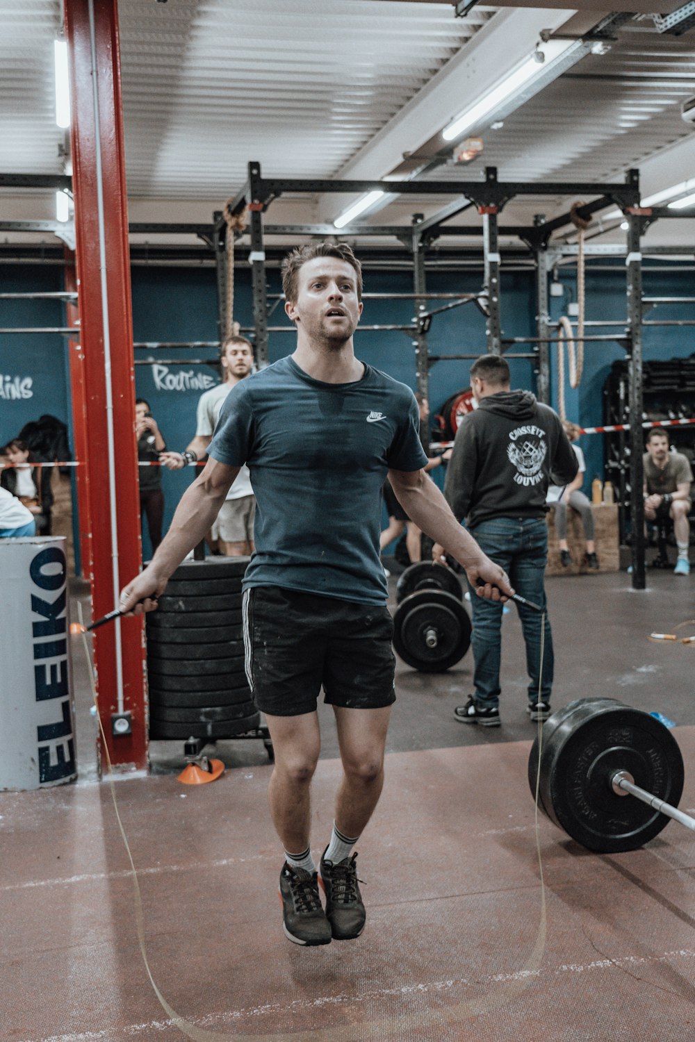 a man holding a barbell in a gym