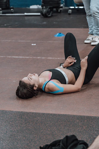 a woman laying on the ground with her leg up