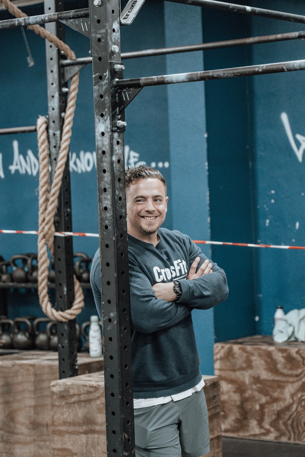 a man standing in front of a metal structure