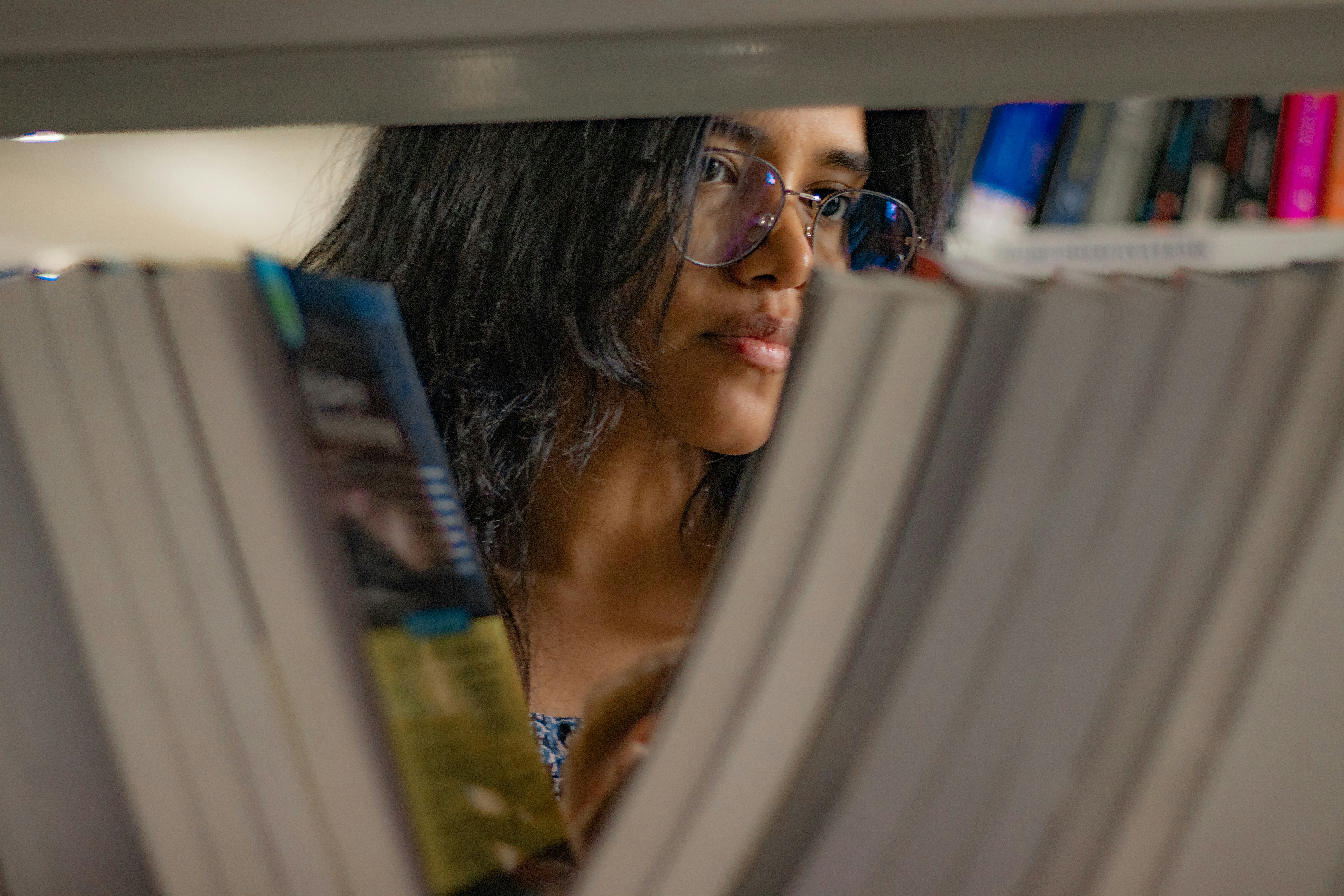 a woman reading a book in a library