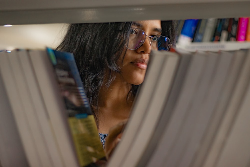 a woman reading a book in a library