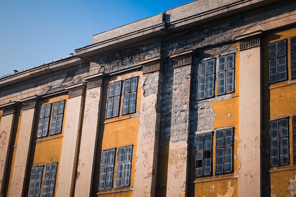 an old building with broken windows and peeling paint