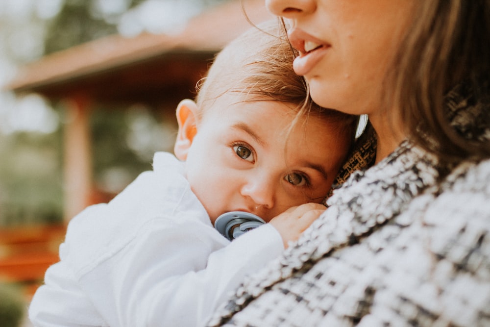 a woman holding a small child in her arms