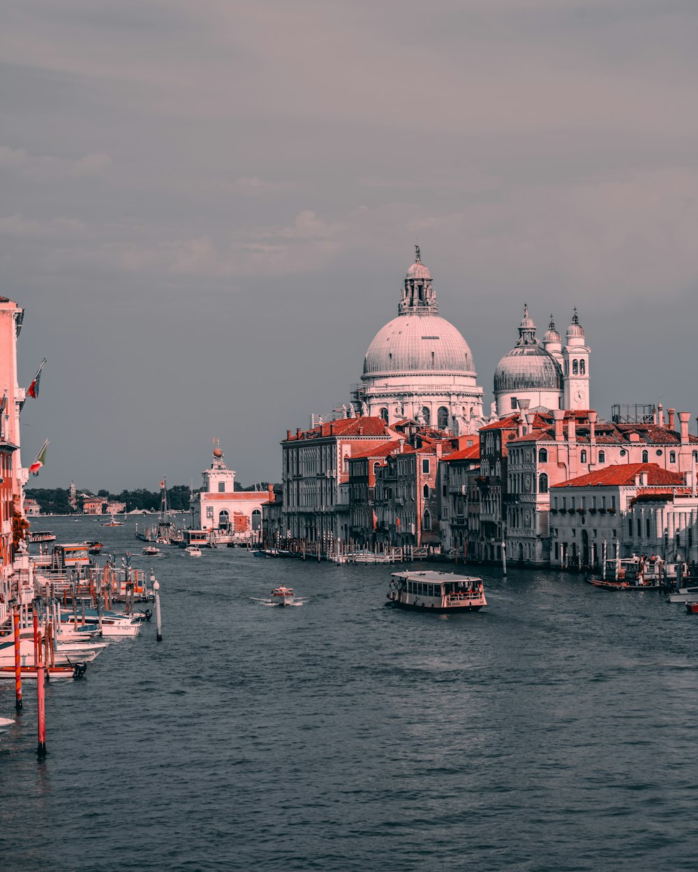 a body of water with boats and buildings in the background