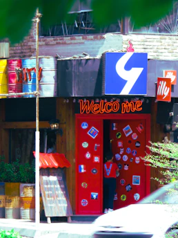 A vibrant local business storefront with a welcoming red door and a Northants Media sign.