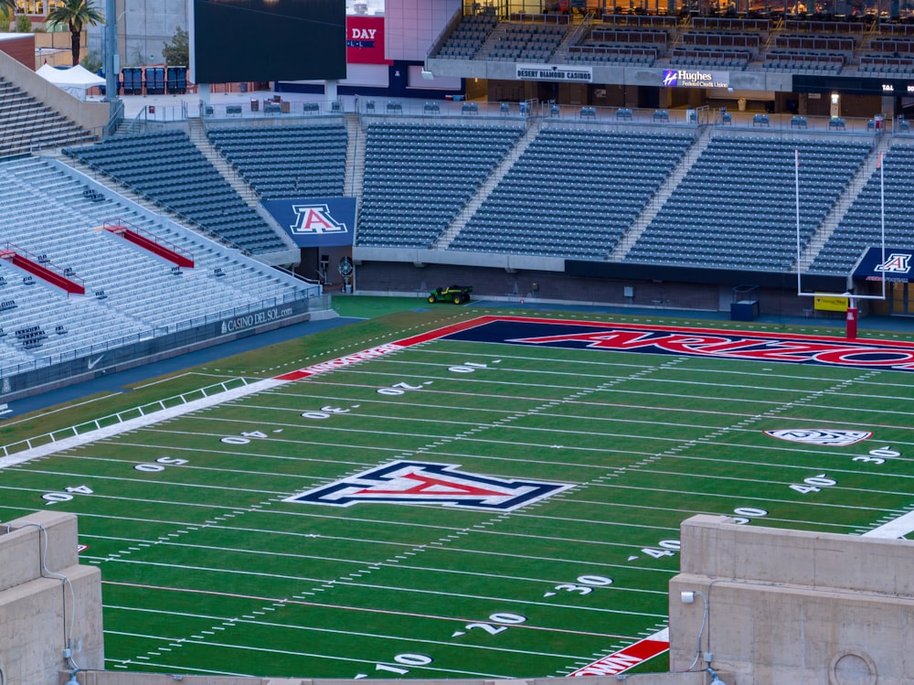 a football field with a stadium in the background