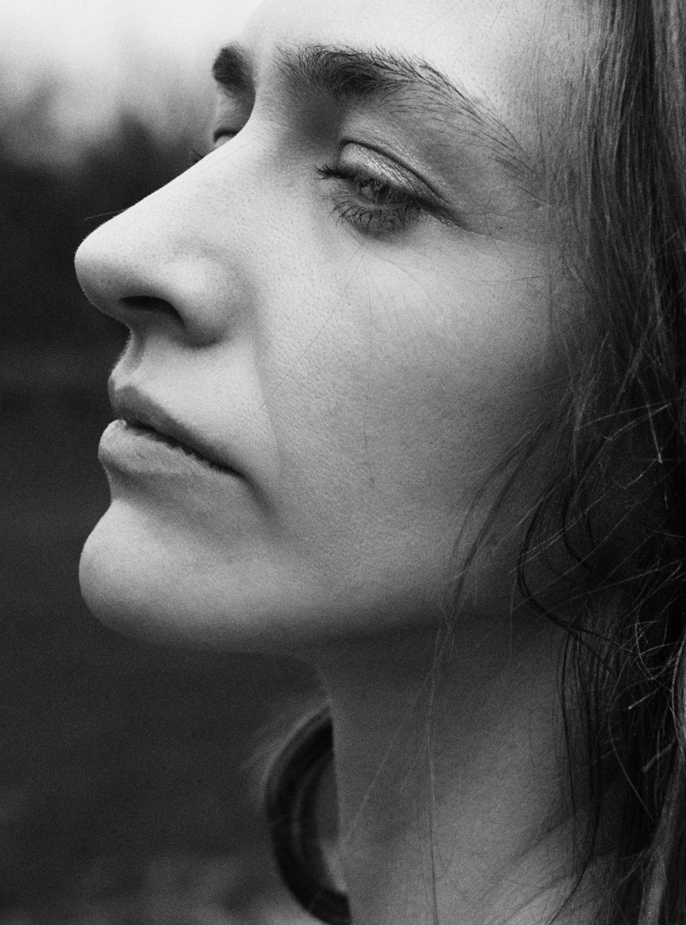 a black and white photo of a woman with her eyes closed