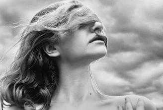 a black and white photo of a woman with her eyes closed
