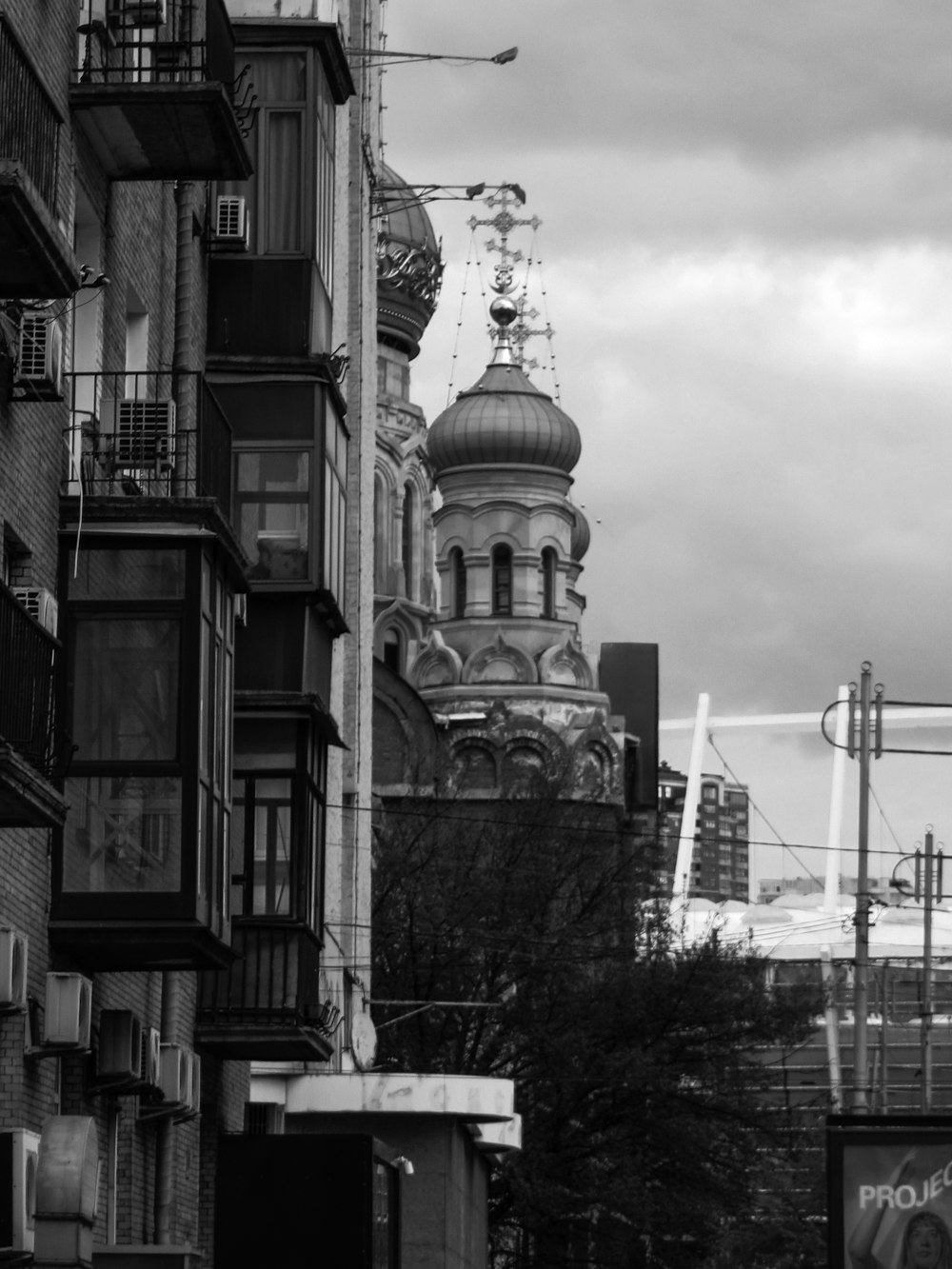 a black and white photo of a church in a city