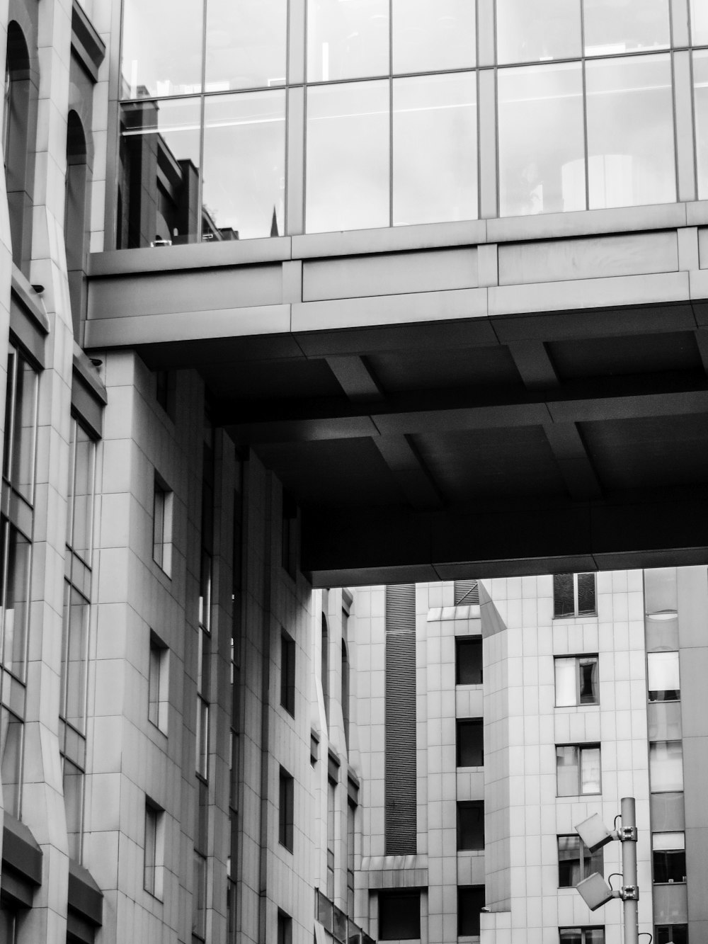 a black and white photo of a bridge over a street