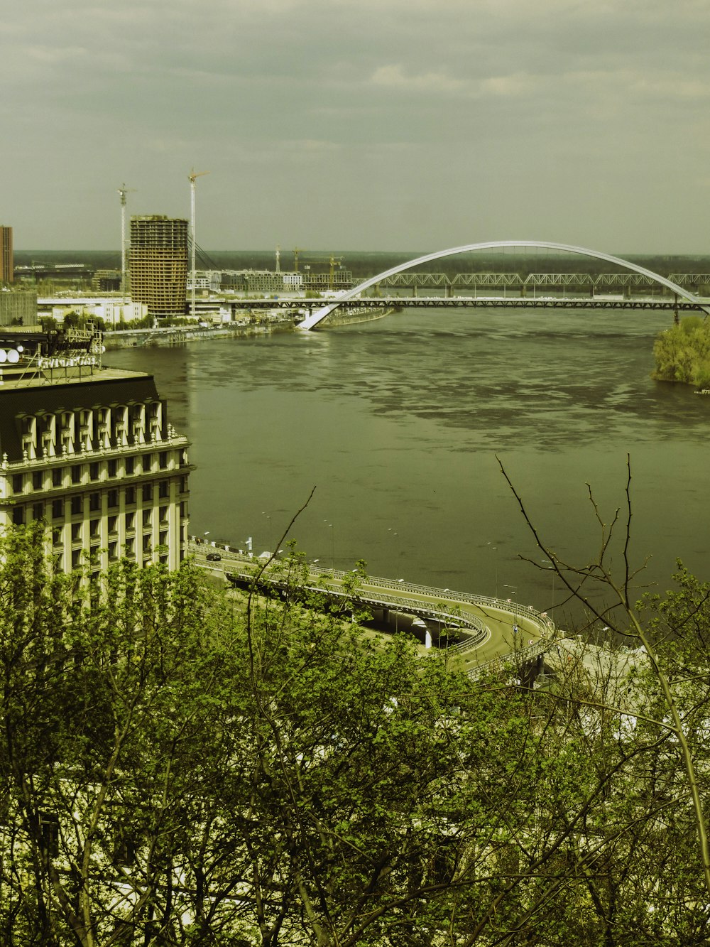 a view of a bridge over a river with a bridge in the background