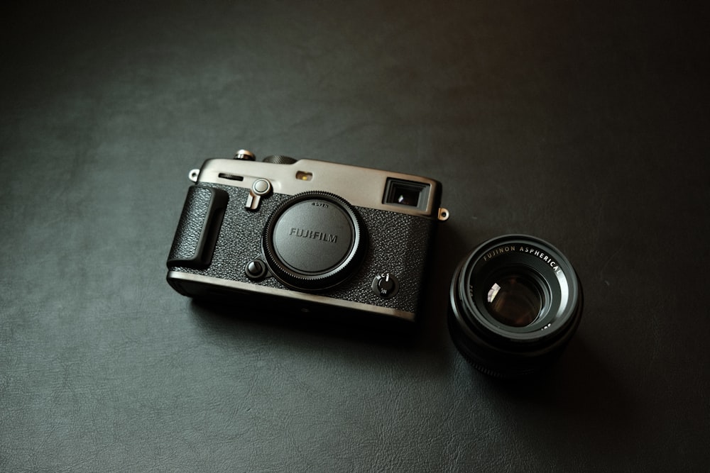 a camera sitting on top of a table next to a lens