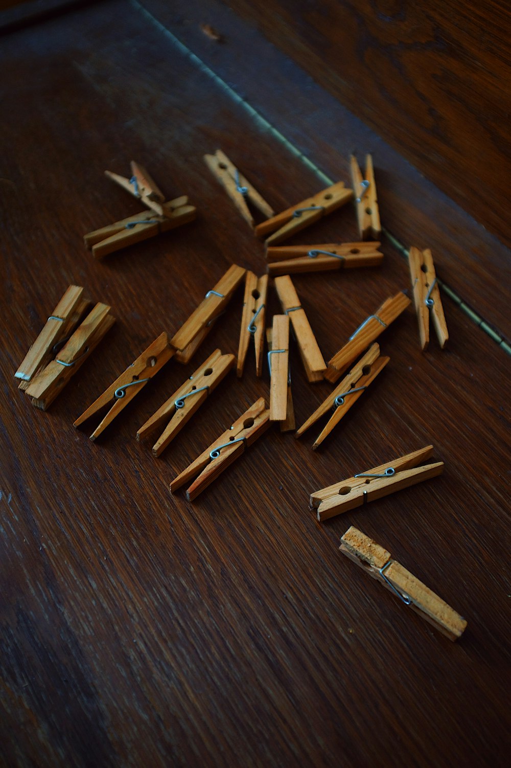 a pile of clothes pins sitting on top of a wooden table