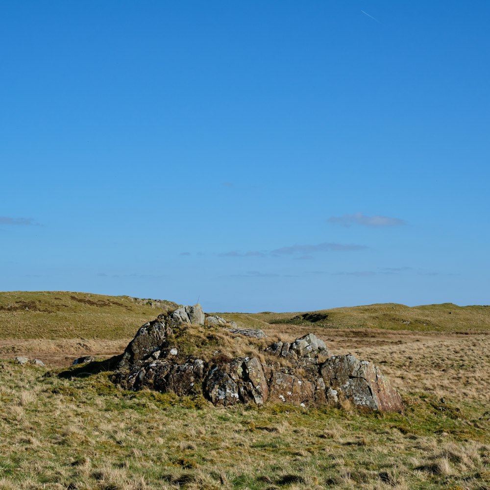 a large rock outcropping in the middle of a field