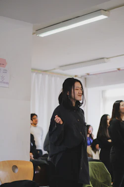 Paula Esther Simeon praying with a small group during a retreat, sunlight filtering through stained glass windows.