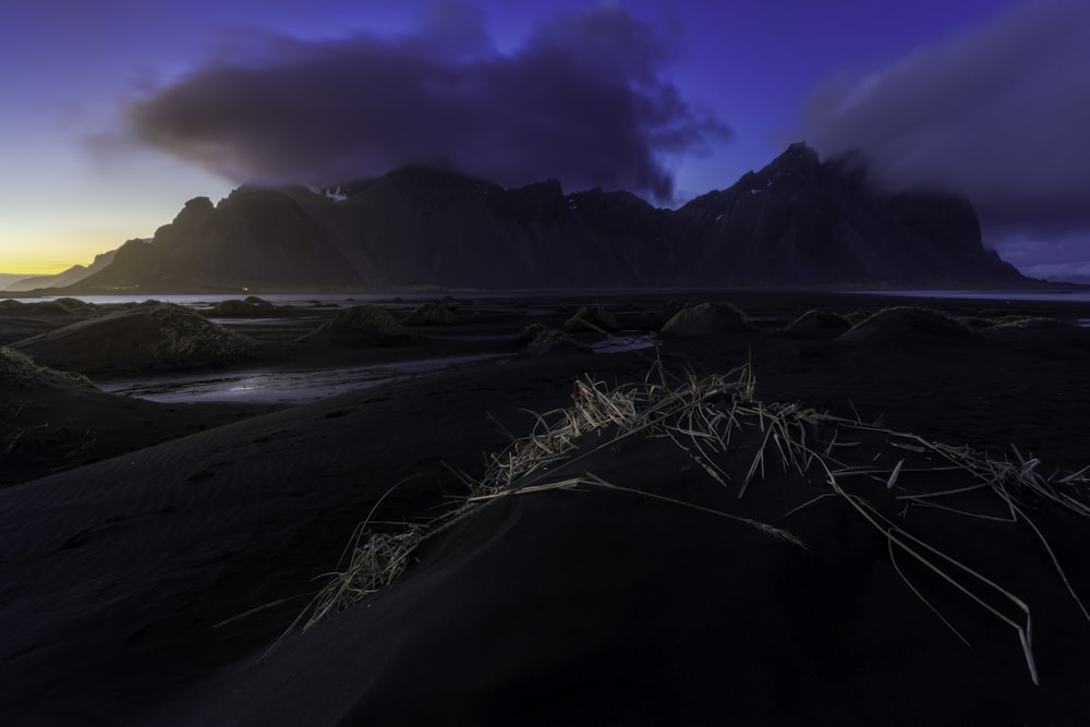 a beach with a mountain in the background