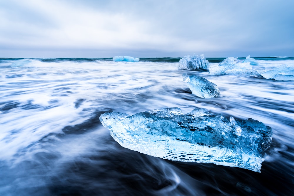 a large iceberg floating on top of a body of water