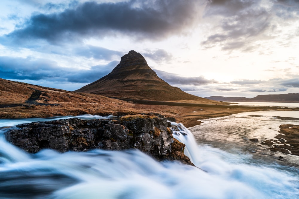 a mountain with a body of water in front of it