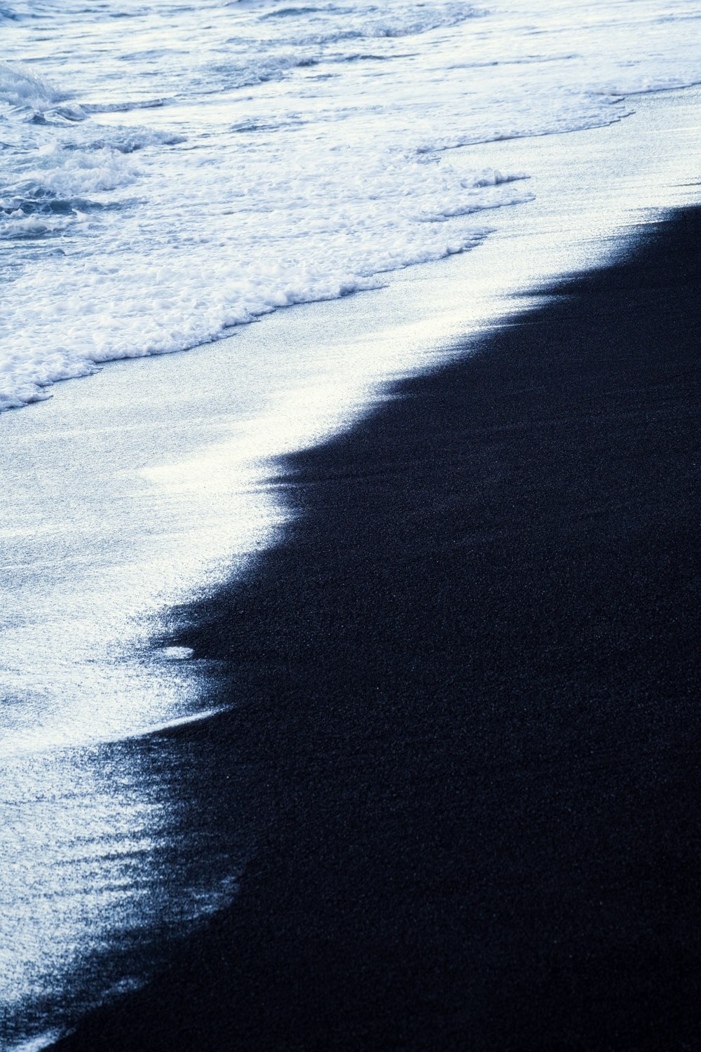 the shadow of a person walking on the beach