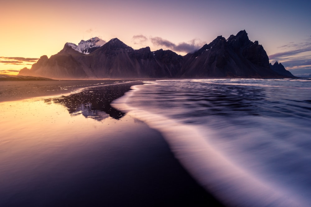 a view of a beach with mountains in the background