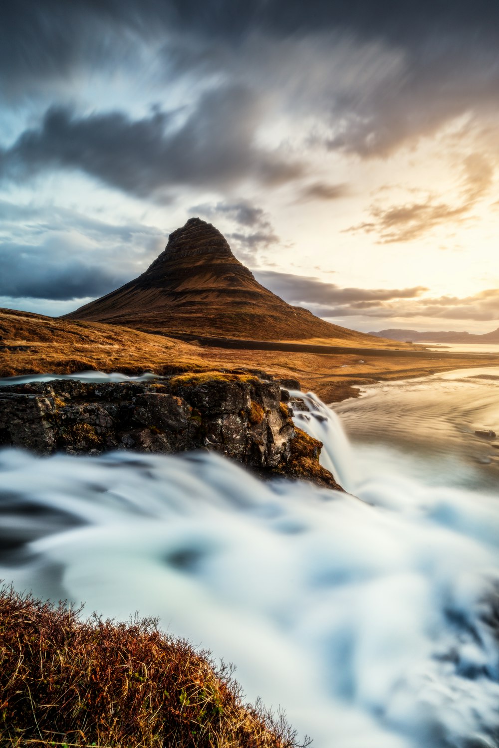 a mountain with a body of water in front of it