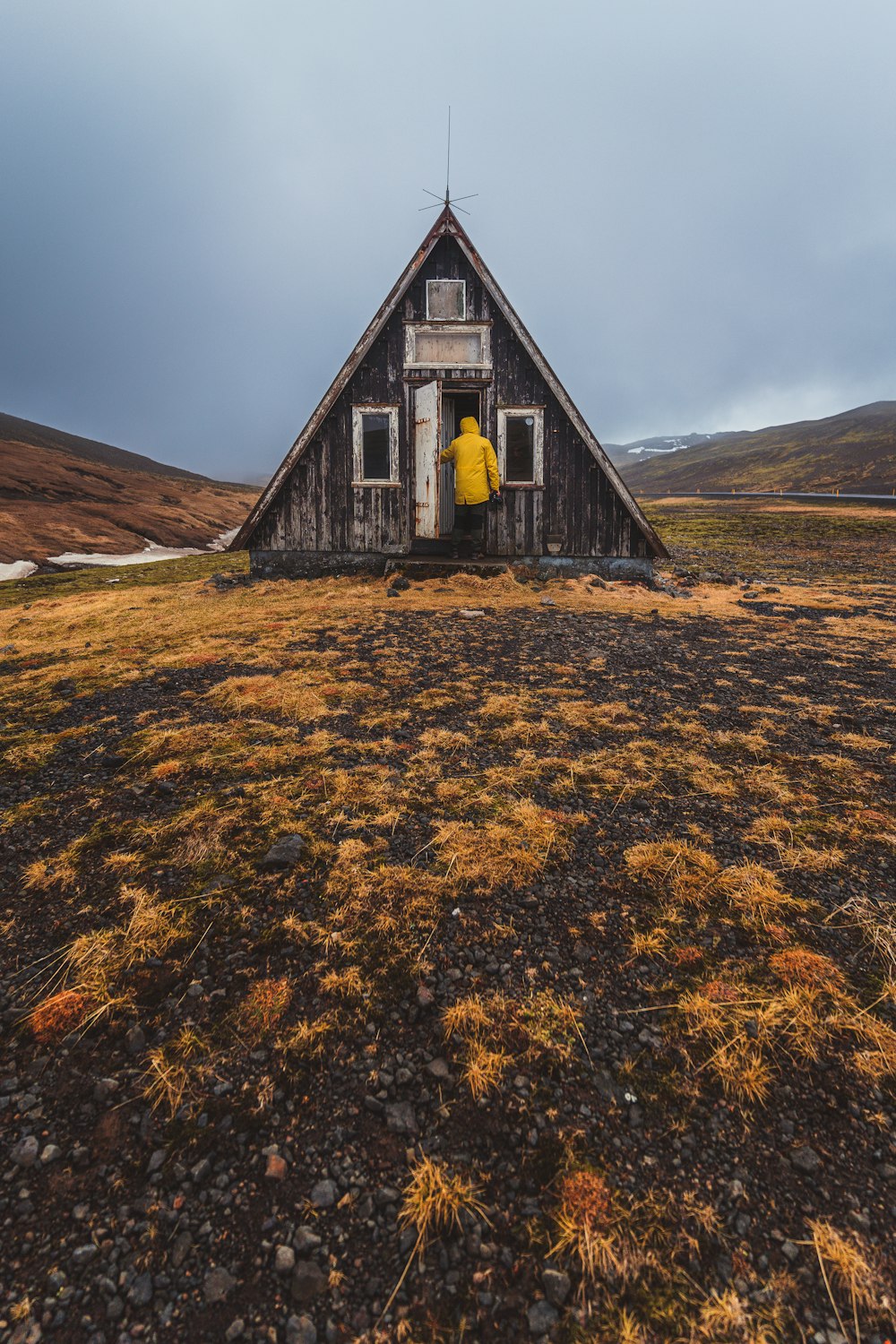 an old building with a yellow jacket on top of it