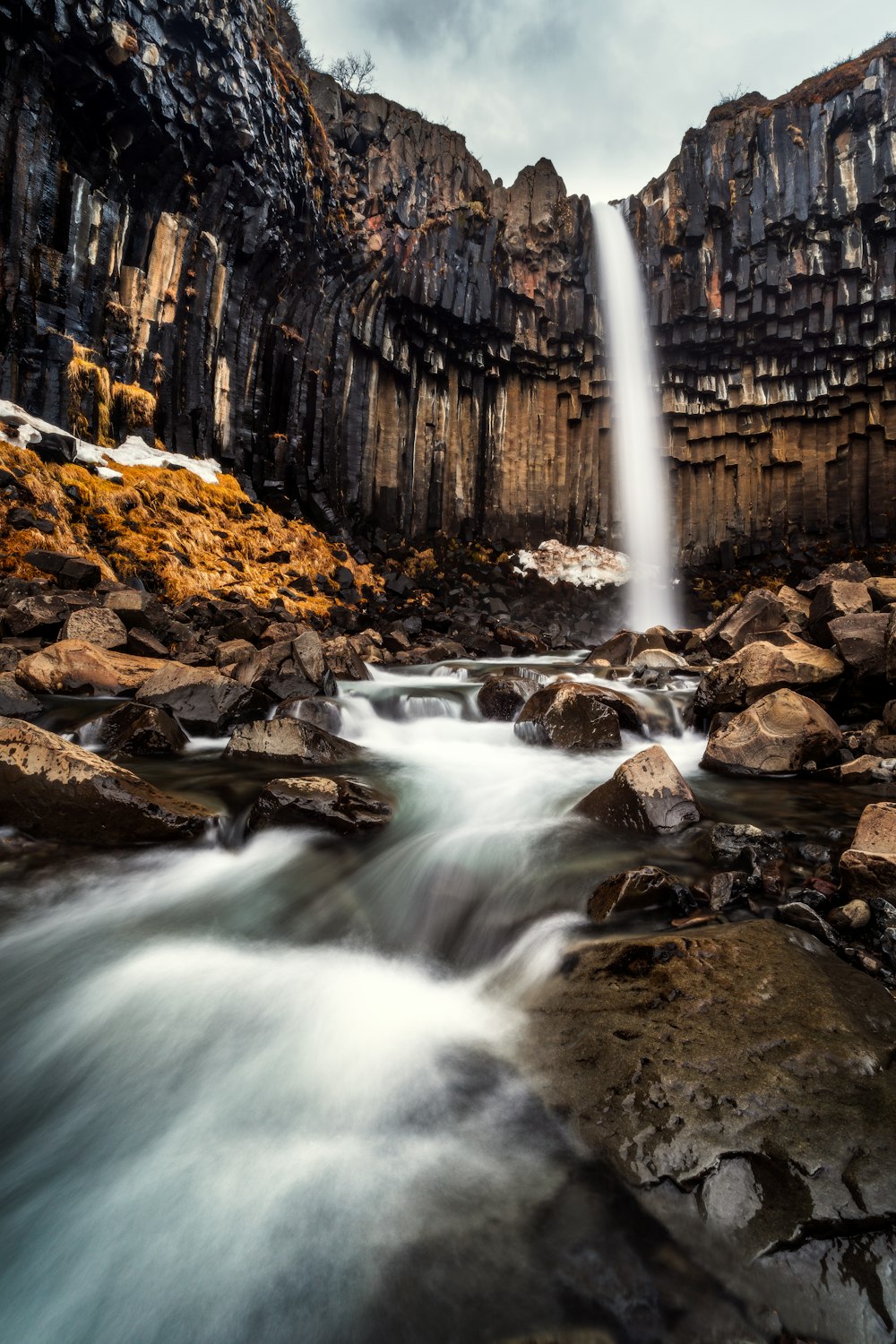 a waterfall in the middle of a rocky area