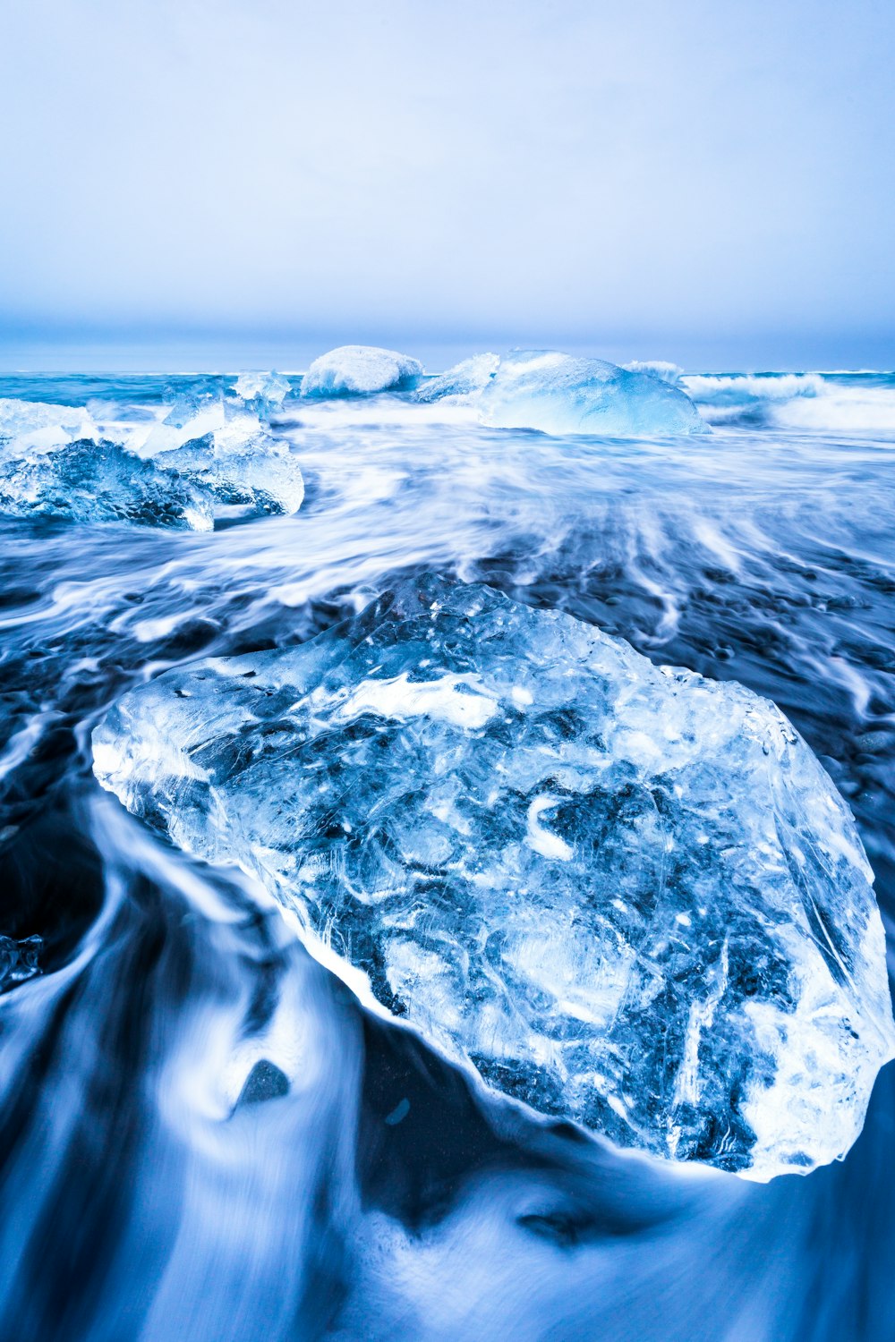 a large iceberg floating on top of a body of water