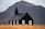 A small black church with white-trimmed windows stands prominently in a grassy field, framed by a rugged mountain in the background under an overcast sky. The structure is simple, featuring a pointed steeple topped with a cross.