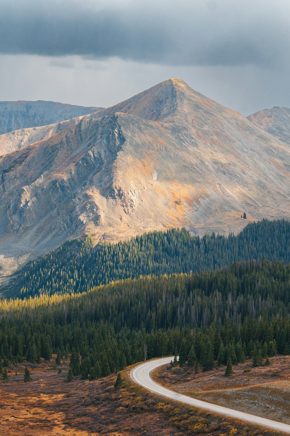 a winding road in the middle of a mountain range