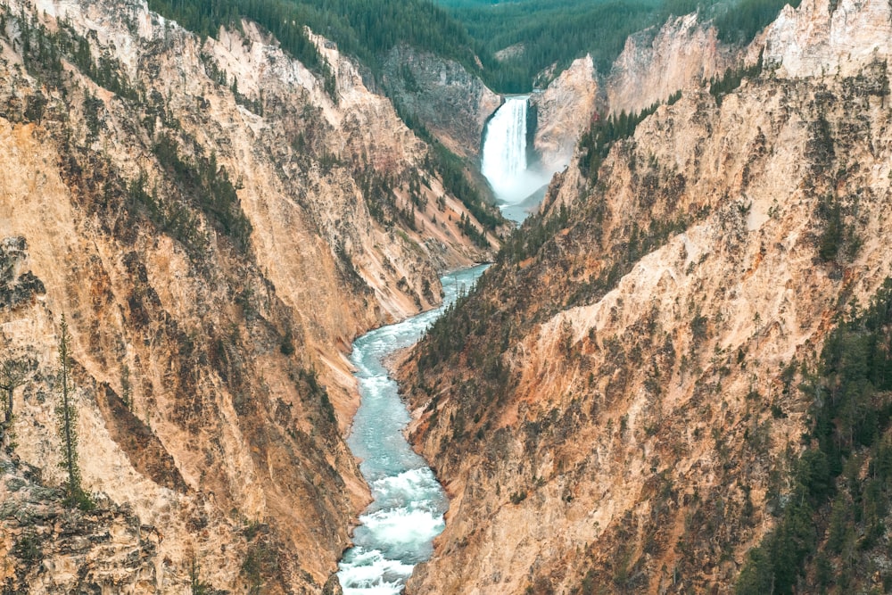 a river flowing through a canyon surrounded by mountains