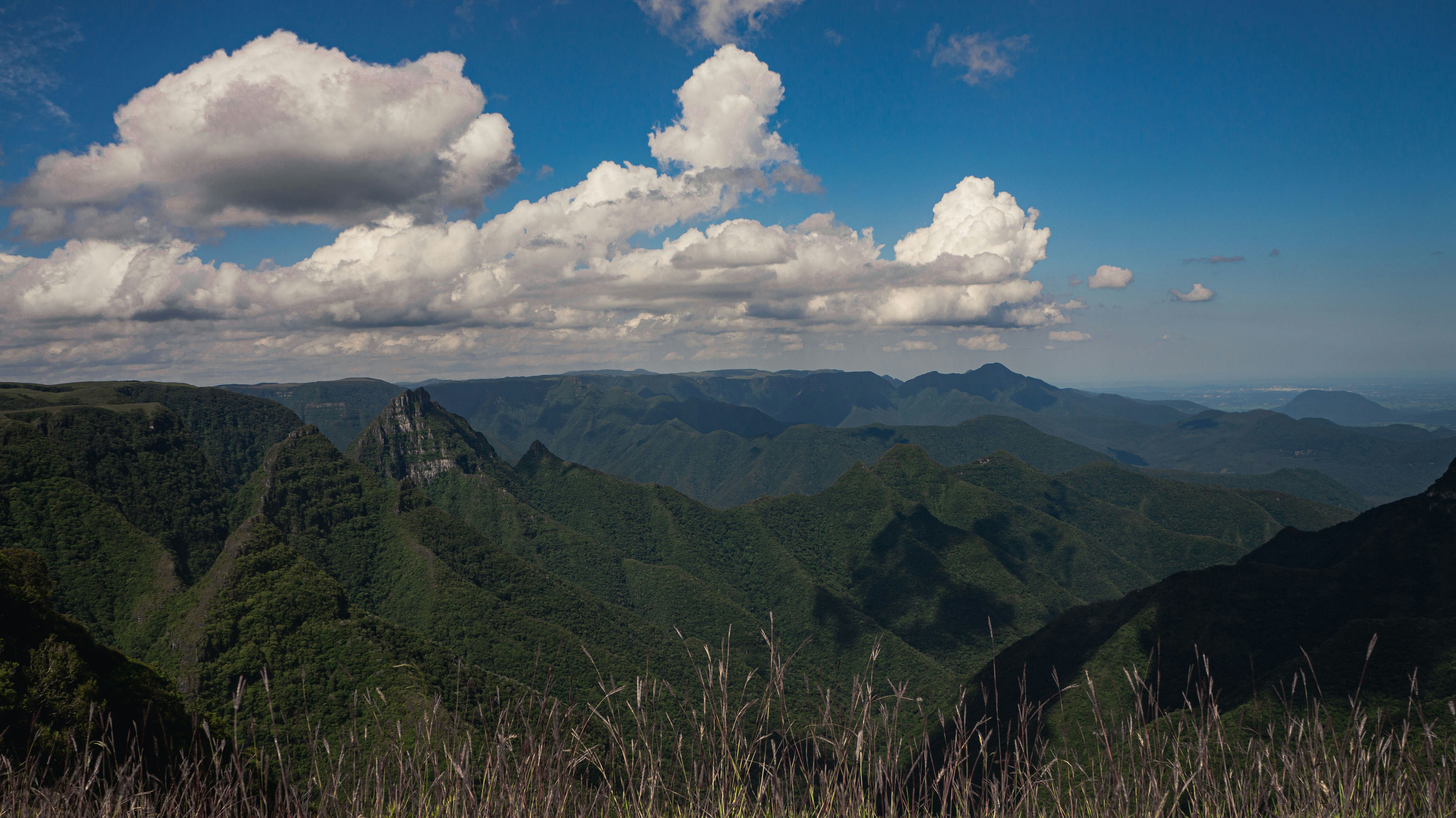 a scenic view of a mountain range with clouds in the sky