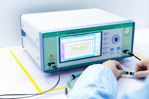 a person working on an electronic device with wires