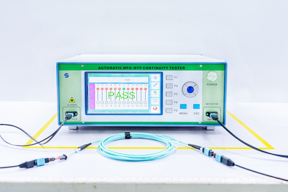 a green and white machine sitting on top of a table