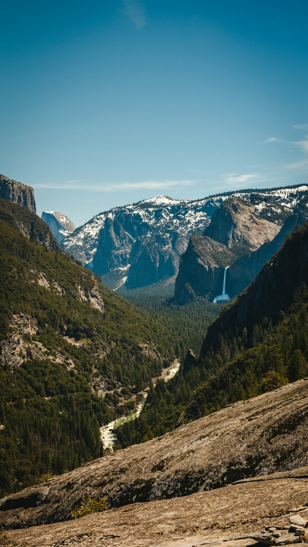 a view of a valley with mountains in the background