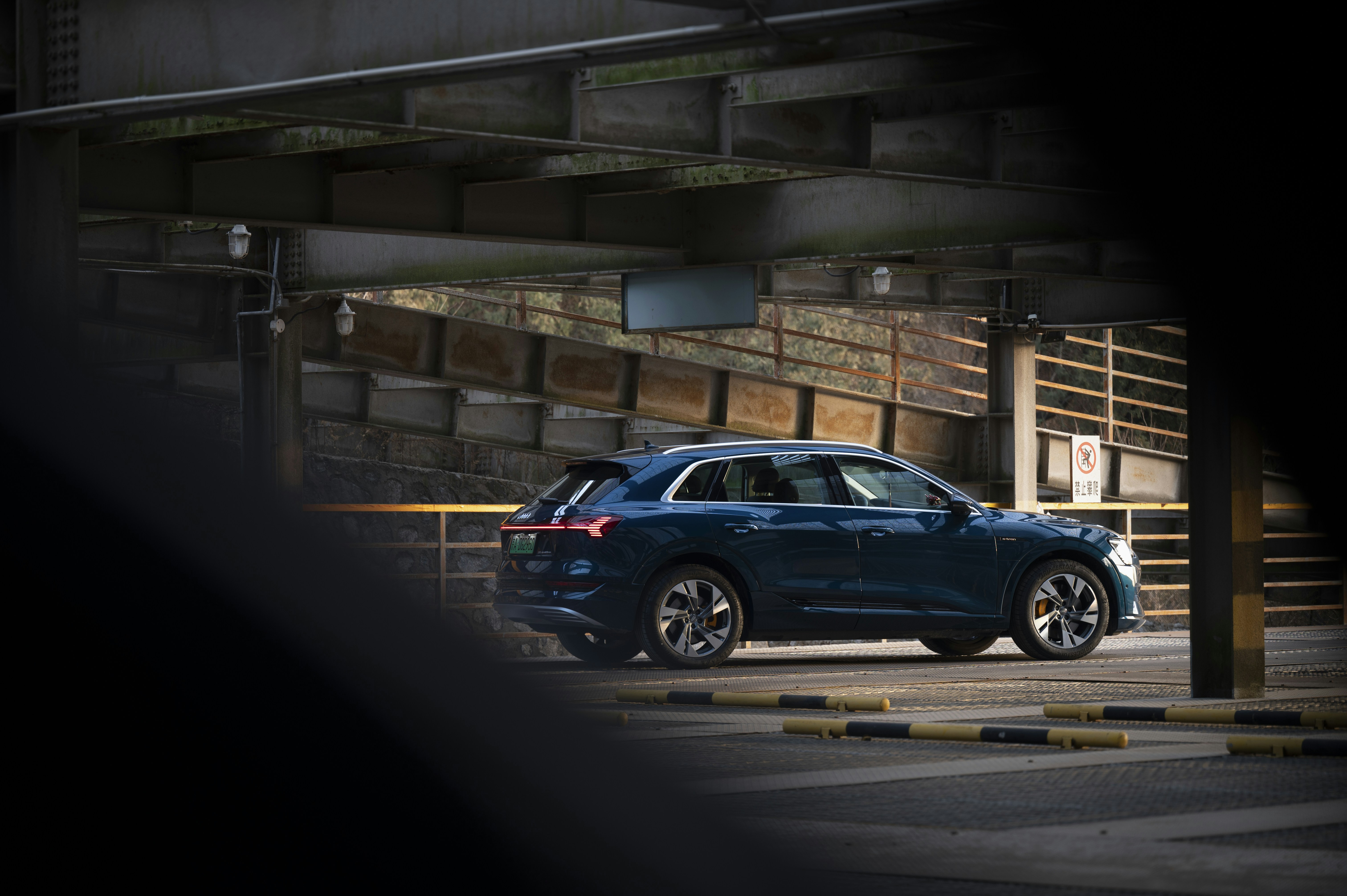 a blue car is parked in a parking lot