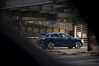 a blue car is parked in a parking lot