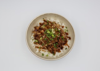 a plate of food with rice and meat