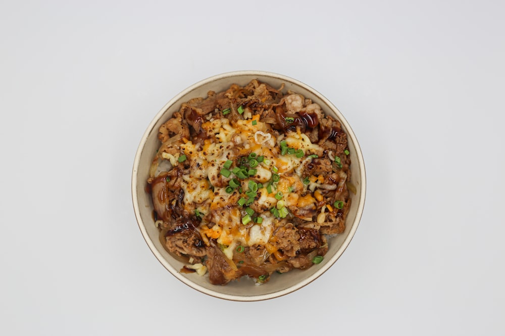 a bowl of food on a white table