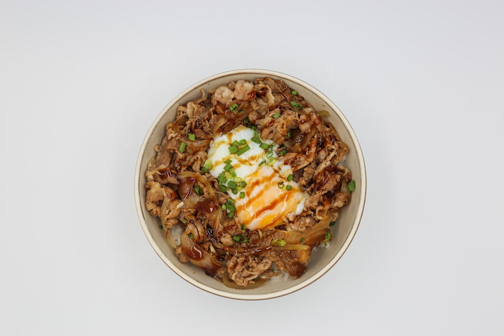 a bowl of food with meat and vegetables