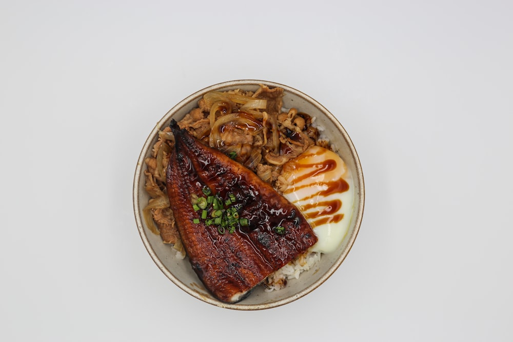 a white plate topped with meat and vegetables