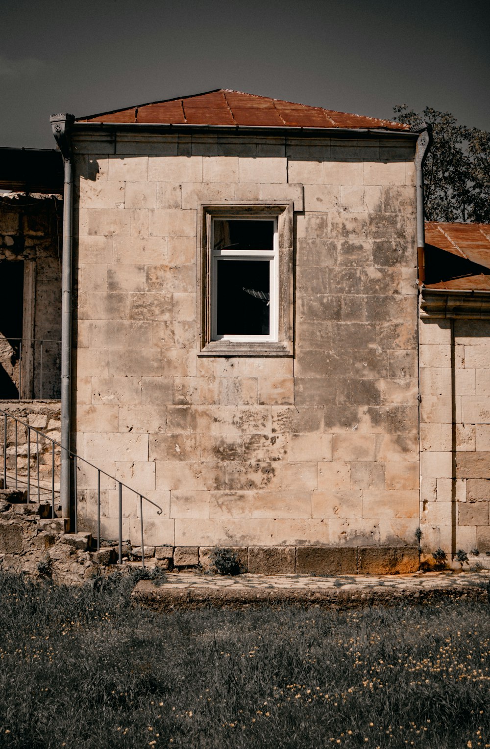 an old building with a red roof and a window